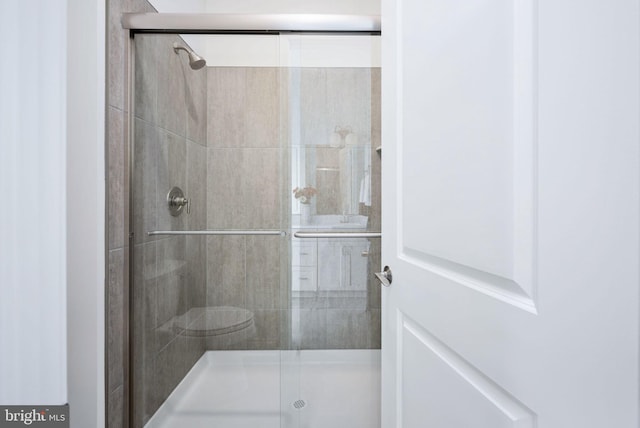 bathroom featuring an enclosed shower and toilet