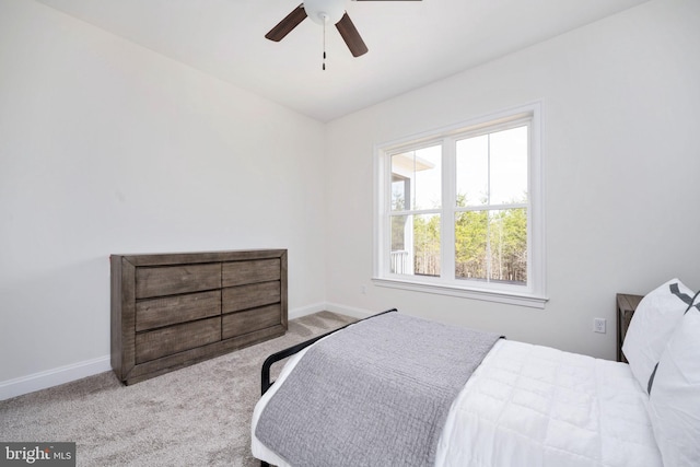 bedroom with ceiling fan and light carpet