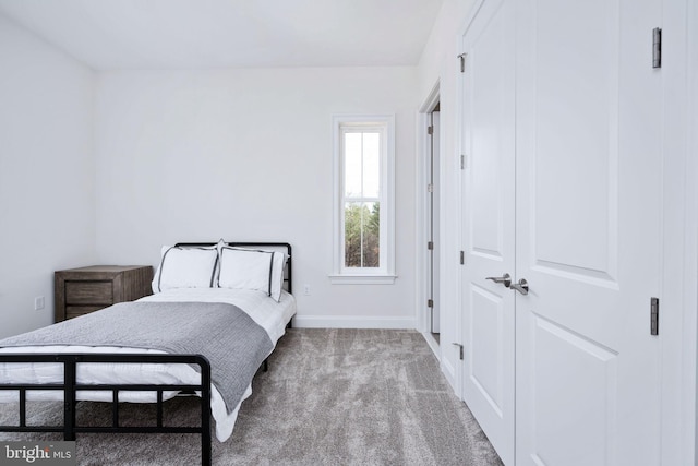 bedroom featuring light colored carpet