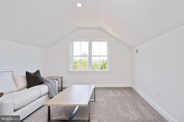 living room with lofted ceiling and light carpet