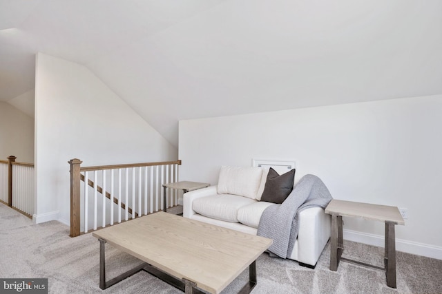 living area featuring vaulted ceiling and light colored carpet