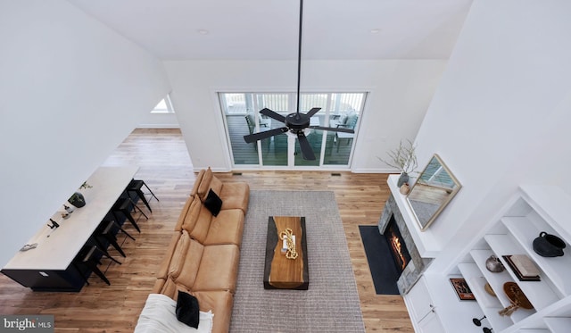 living room featuring ceiling fan and light hardwood / wood-style flooring