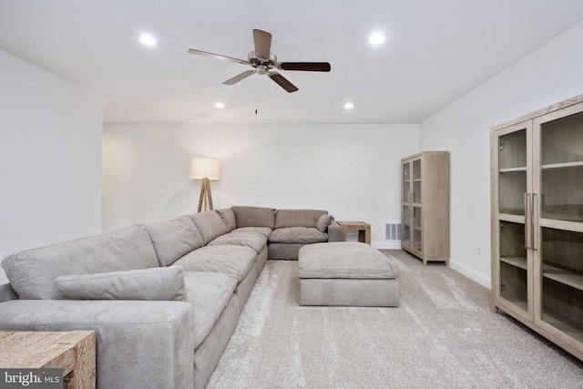 living room with ceiling fan and light colored carpet