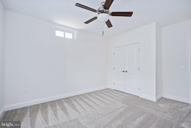 unfurnished bedroom with light carpet, a closet, and ceiling fan