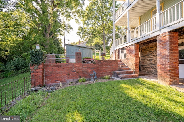 view of yard with a balcony