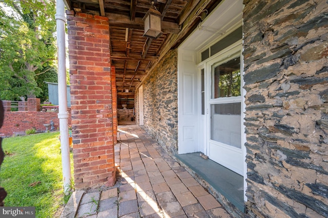 view of exterior entry featuring stone siding