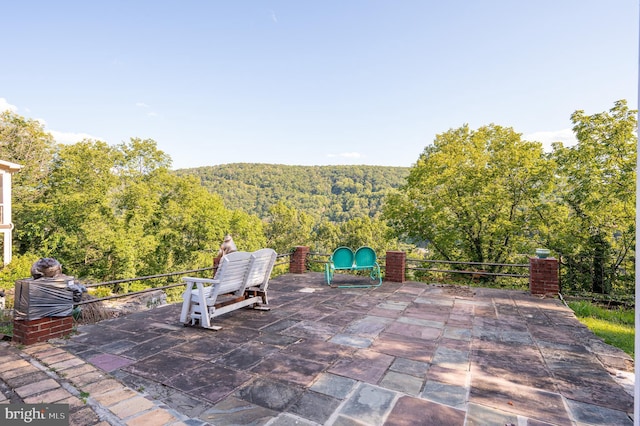 view of patio with a view of trees