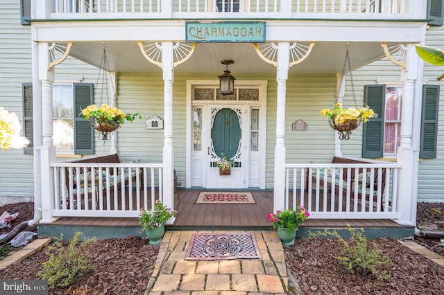 entrance to property featuring a porch