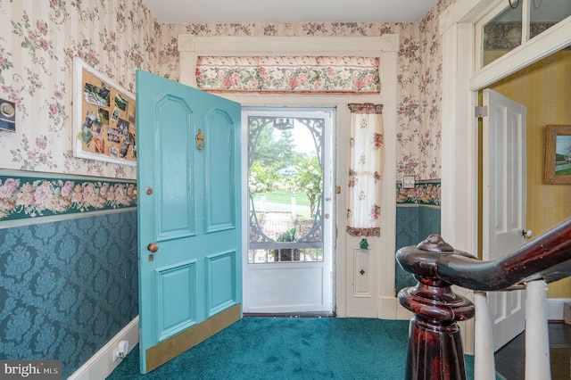 entryway with wainscoting and wallpapered walls