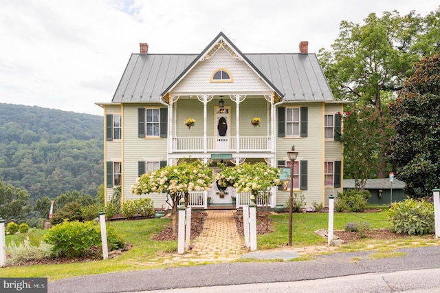 victorian house with covered porch and a front yard