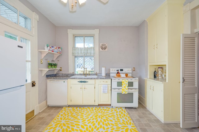 kitchen featuring white appliances, a sink, baseboards, and open shelves