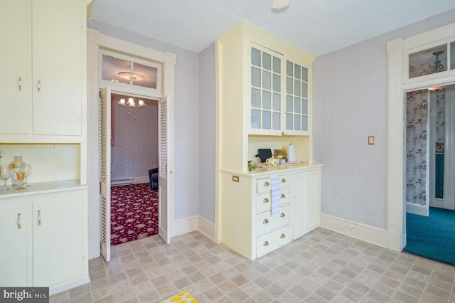 hall with a chandelier and baseboards