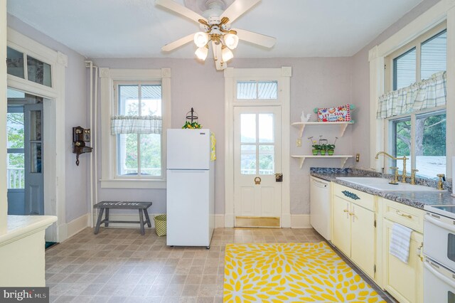 kitchen with white appliances, light tile patterned flooring, sink, and ceiling fan