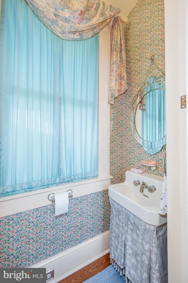 bathroom with wallpapered walls