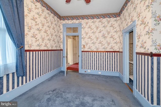 empty room with carpet, ceiling fan, and wallpapered walls