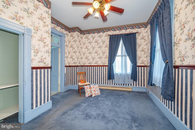 carpeted empty room featuring ceiling fan