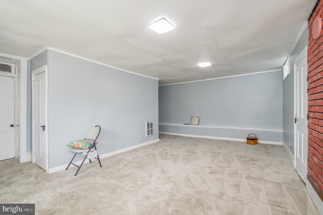 interior space with carpet and brick wall