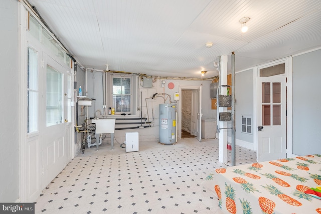 interior space featuring electric water heater, sink, and carpet floors