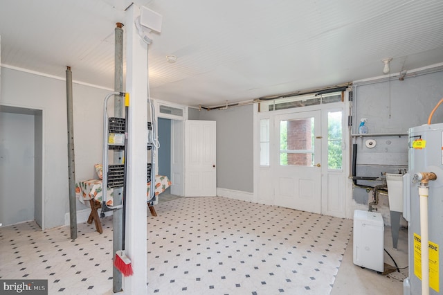 interior space with electric water heater and light floors