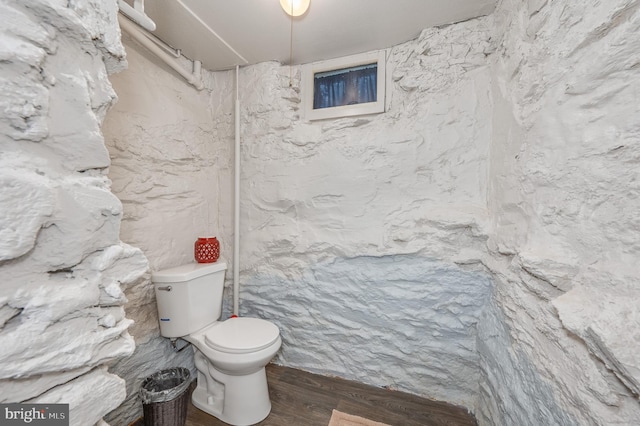 bathroom featuring wood finished floors and toilet