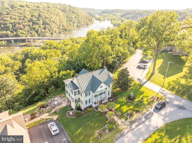 drone / aerial view featuring a wooded view