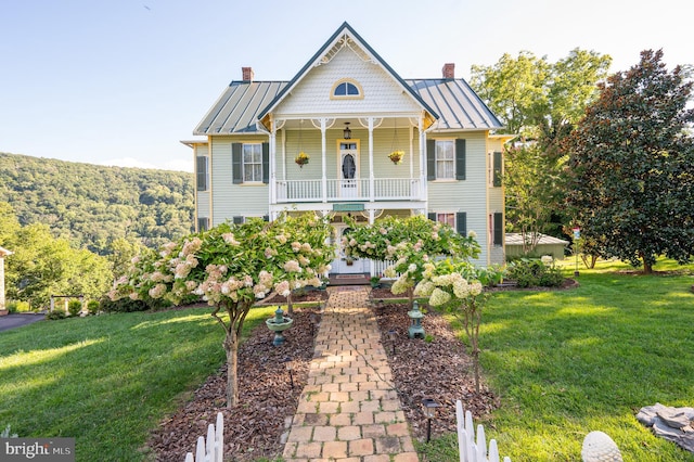 victorian-style house with covered porch and a front yard