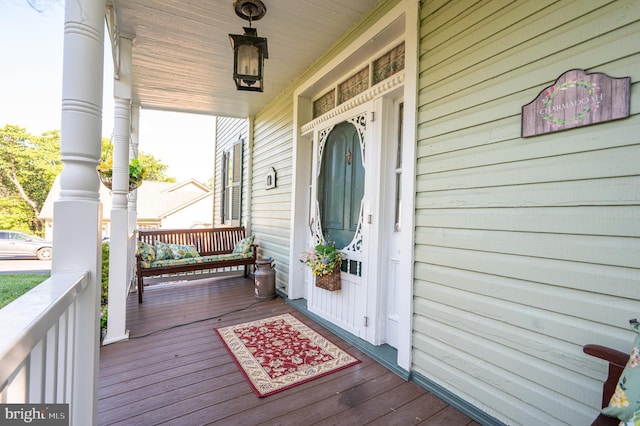 view of exterior entry featuring covered porch