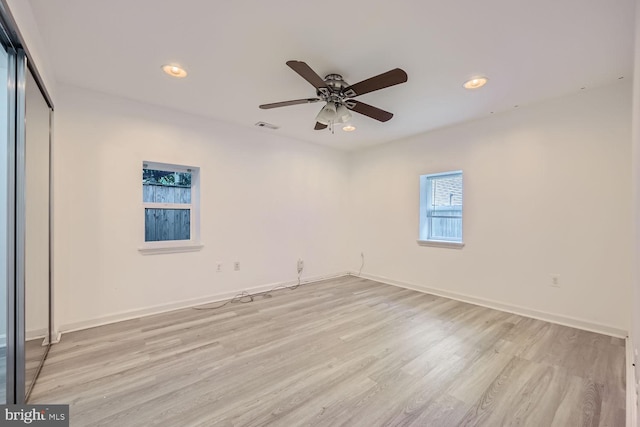 unfurnished bedroom with light hardwood / wood-style flooring, a closet, and ceiling fan