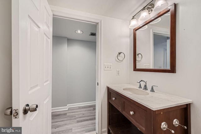 bathroom featuring wood-type flooring and vanity