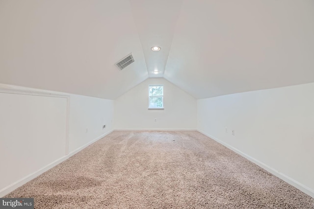 bonus room with carpet floors and lofted ceiling