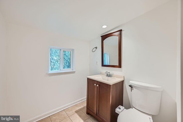 bathroom with tile patterned flooring, vanity, and toilet