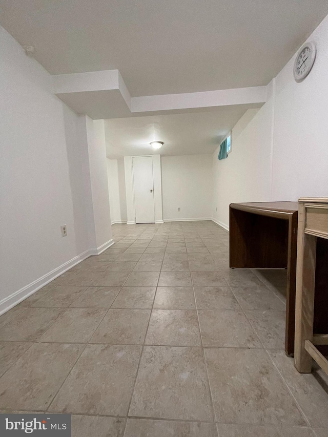 basement featuring light tile patterned flooring