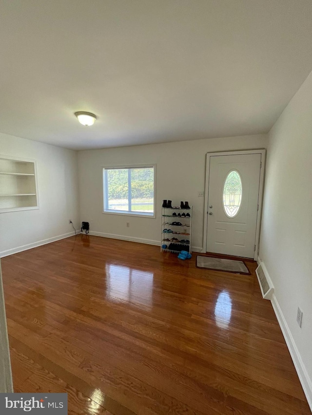 entrance foyer with dark hardwood / wood-style floors