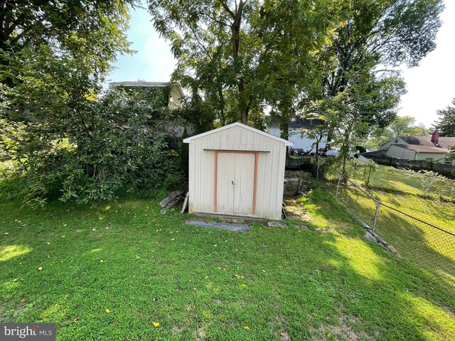 view of outbuilding with a yard