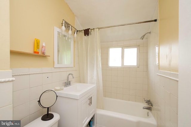 full bathroom featuring vanity, tile walls, shower / tub combo, and toilet