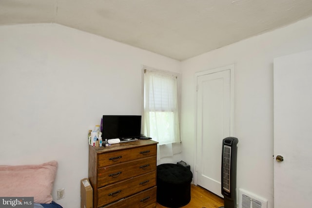 sitting room with lofted ceiling and light wood-type flooring