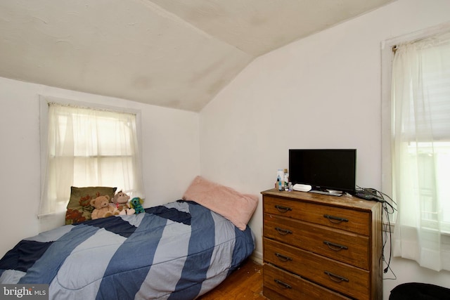 bedroom featuring vaulted ceiling and wood-type flooring