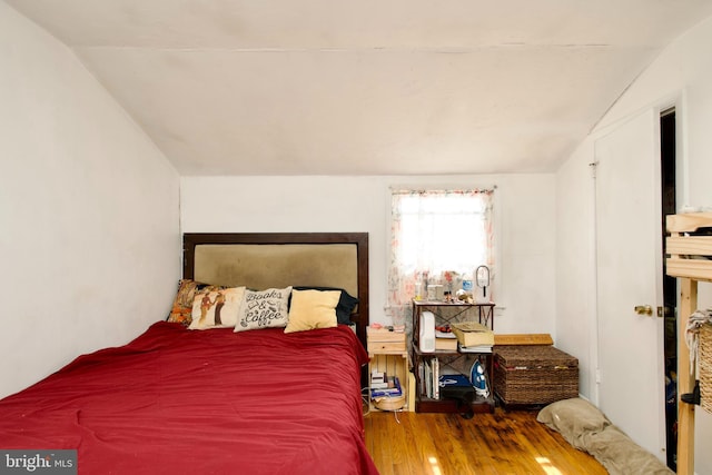 bedroom featuring vaulted ceiling and dark hardwood / wood-style floors