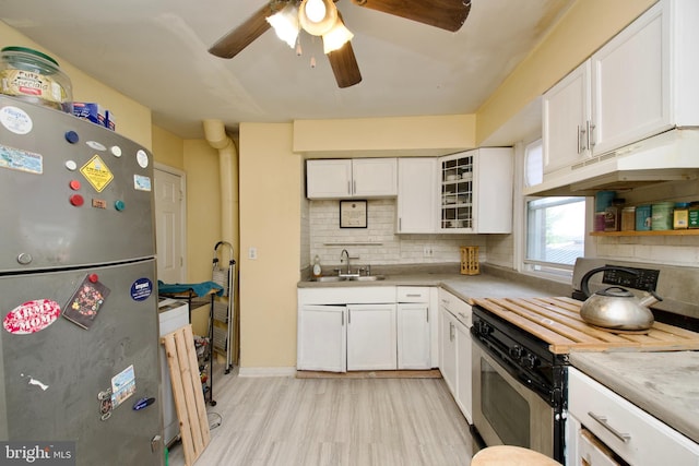 kitchen with white cabinets, sink, stainless steel appliances, and ceiling fan