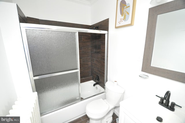 full bathroom featuring combined bath / shower with glass door, toilet, and vanity