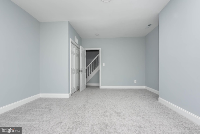 unfurnished bedroom featuring light colored carpet