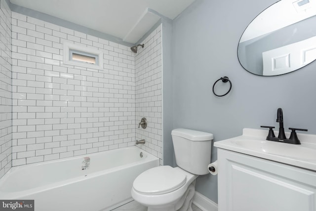 full bathroom featuring vanity, tiled shower / bath, and toilet