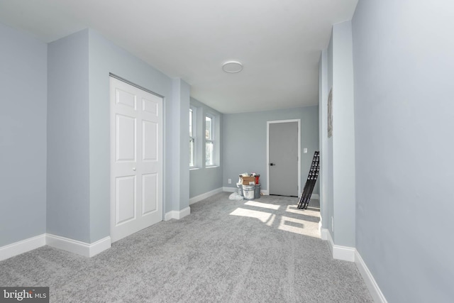 entryway with light colored carpet