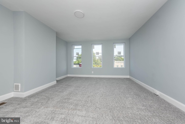 unfurnished room featuring light colored carpet