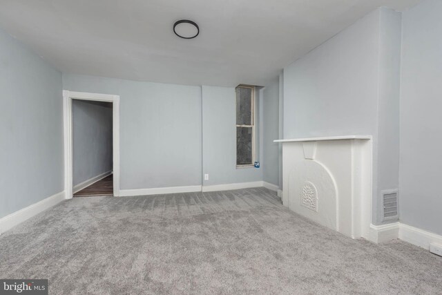 unfurnished living room featuring carpet floors