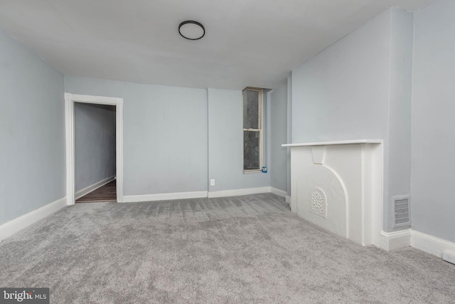 unfurnished living room featuring carpet flooring