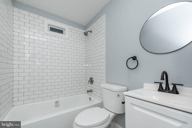 full bathroom with vanity, tiled shower / bath combo, and toilet