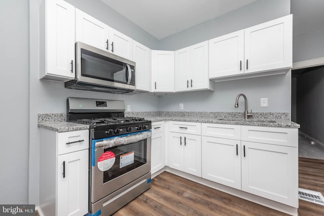 kitchen with white cabinetry, sink, and stainless steel appliances