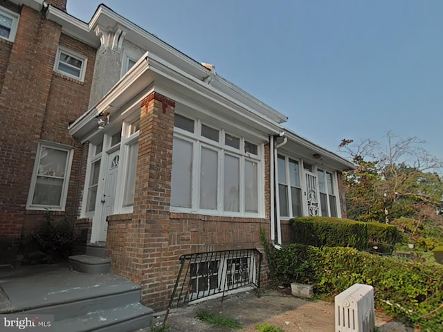 view of side of home featuring brick siding