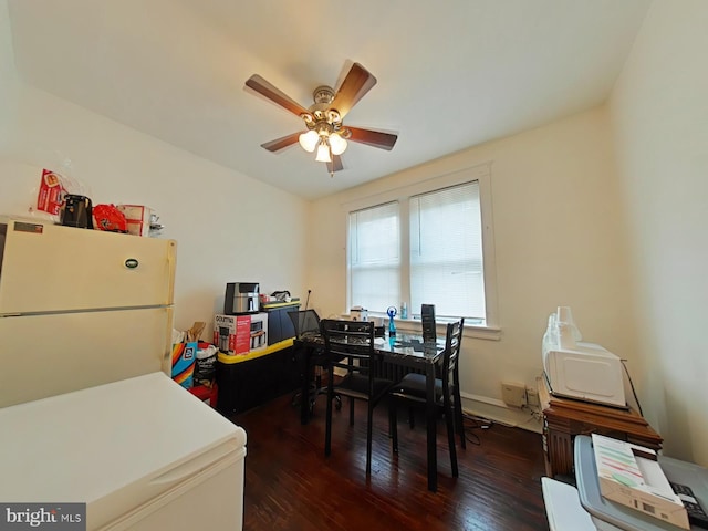 dining room with a ceiling fan and dark wood-style flooring